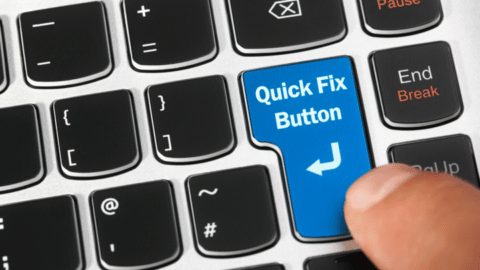 A keyboard with a button labeled Quick Fix Button